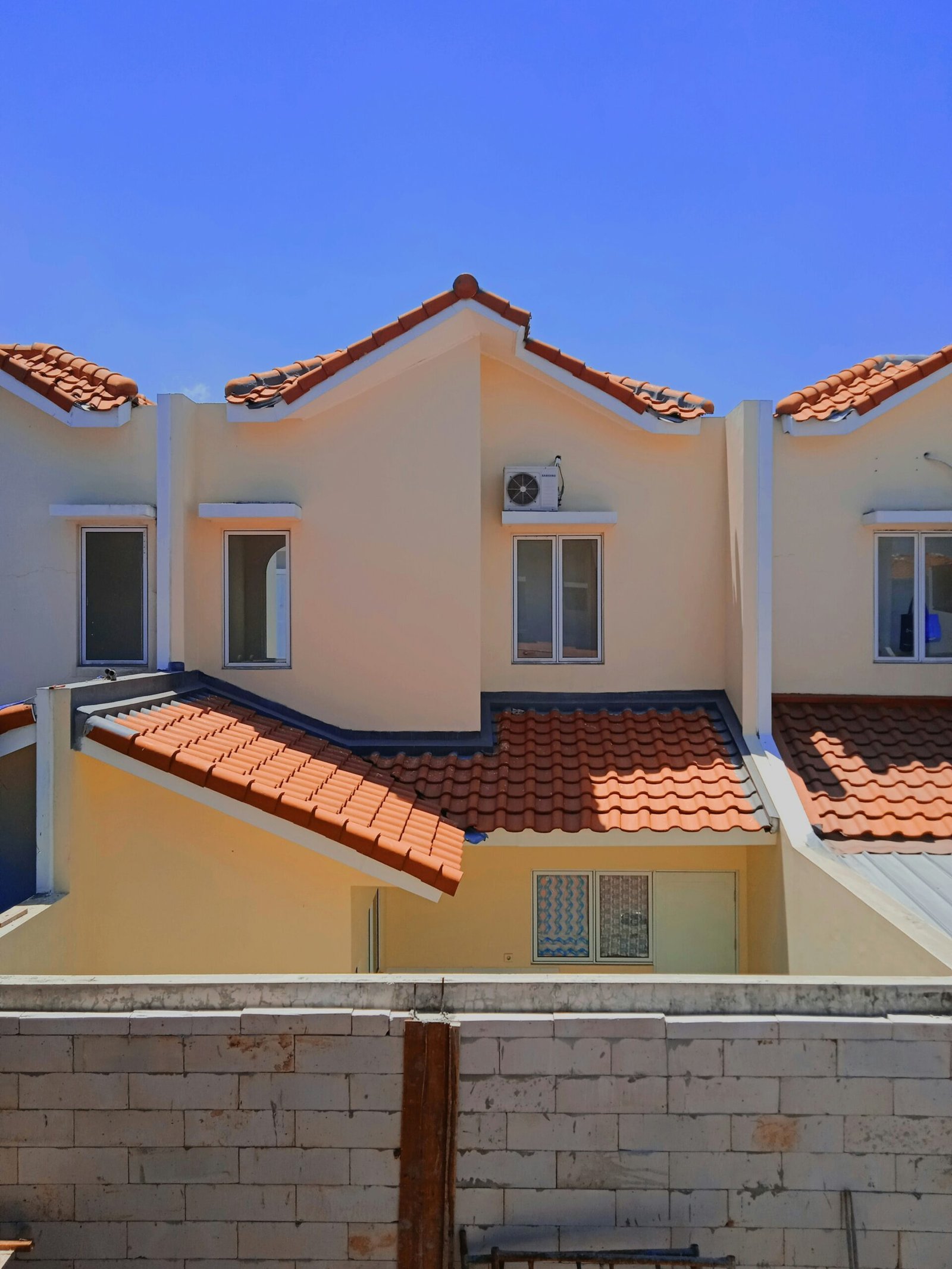 a row of houses with red tiled roofs